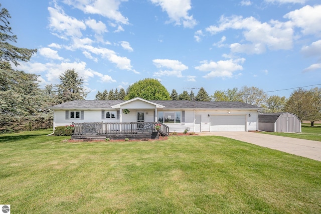 6450 W Lincoln Rd, Elwell, MI 48832 - ranch-style home with concrete driveway, an attached garage, a storage unit, and a front yard