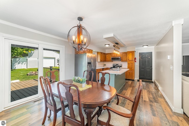 6450 W Lincoln Rd, Elwell, MI 48832 - dining space with a chandelier, wood finished floors, crown molding, and baseboards