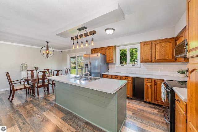 6450 W Lincoln Rd, Elwell, MI 48832 - kitchen featuring appliances with stainless steel finishes, a sink, light countertops, tasteful backsplash, and crown molding