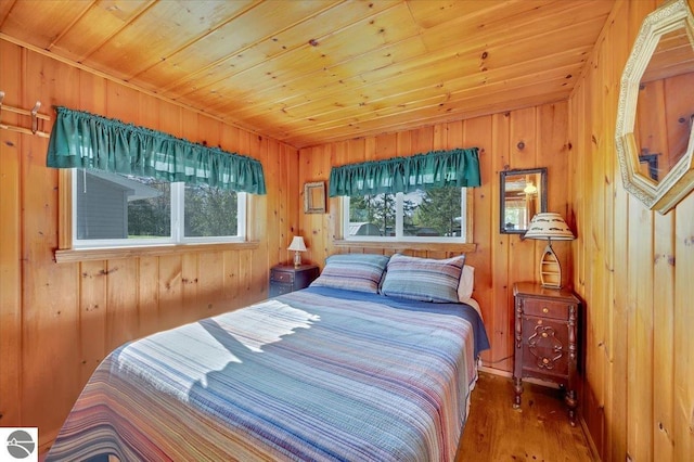 bedroom featuring wood finished floors, wood walls, and wood ceiling
