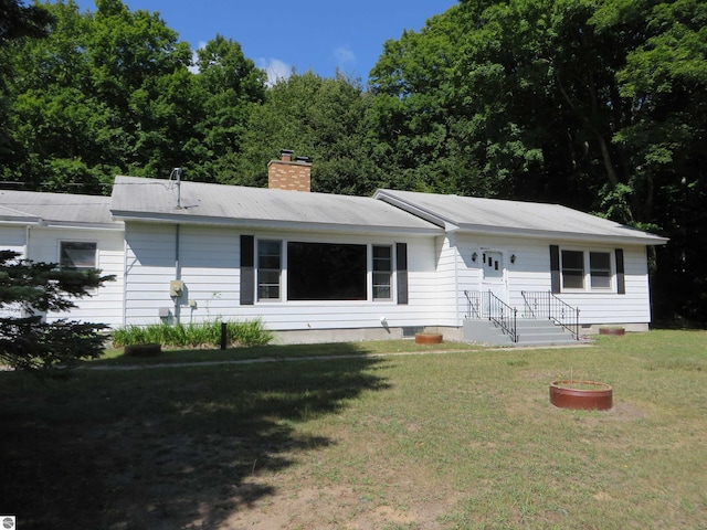 7548 S Dune Hwy, Empire, MI 49630 - ranch-style home featuring a chimney and a front lawn