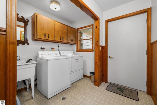 7548 S Dune Hwy, Empire, MI 49630 - washroom with separate washer and dryer, cabinet space, and light flooring