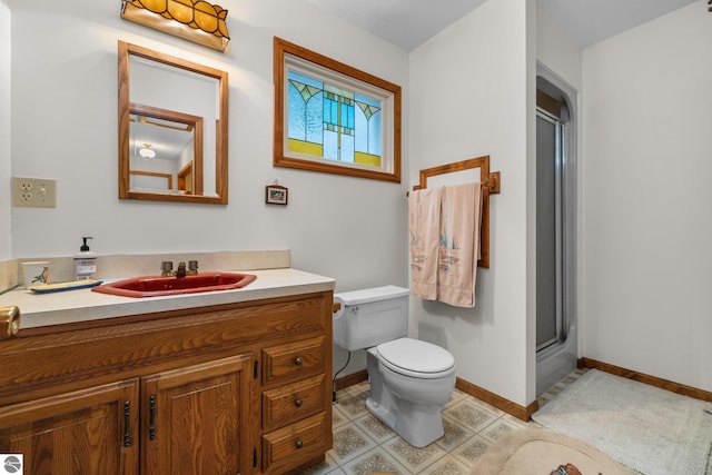 7548 S Dune Hwy, Empire, MI 49630 - bathroom with a shower with shower door, baseboards, toilet, and vanity