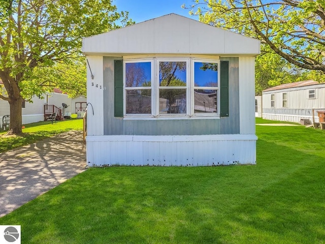 411 S Grover Ave Lot 39, Alma, MI 48801 - view of home's exterior with a lawn