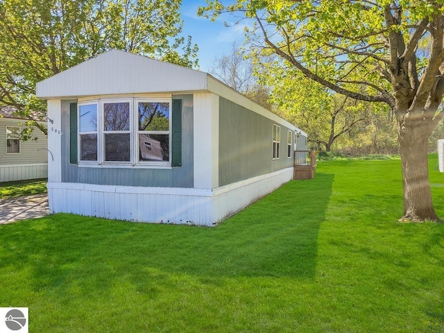 411 S Grover Ave Lot 39, Alma, MI 48801 - view of home's exterior featuring a lawn