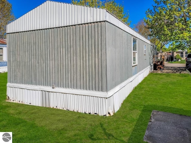 411 S Grover Ave Lot 39, Alma, MI 48801 - view of side of home featuring a yard