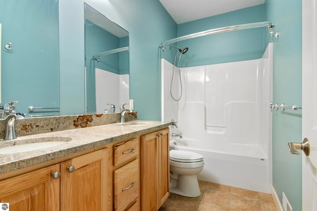 8233 Barney Rd, Traverse City, MI 49684 - bathroom featuring double vanity, toilet, and bathtub / shower combination