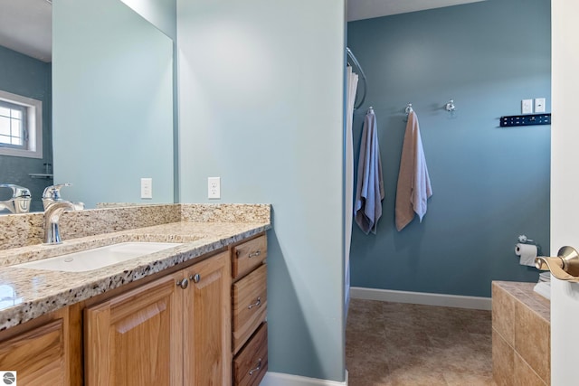 8233 Barney Rd, Traverse City, MI 49684 - bathroom featuring baseboards and vanity
