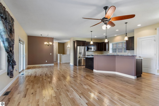 8233 Barney Rd, Traverse City, MI 49684 - kitchen with stainless steel appliances, dark brown cabinets, light wood-type flooring, ceiling fan, and recessed lighting