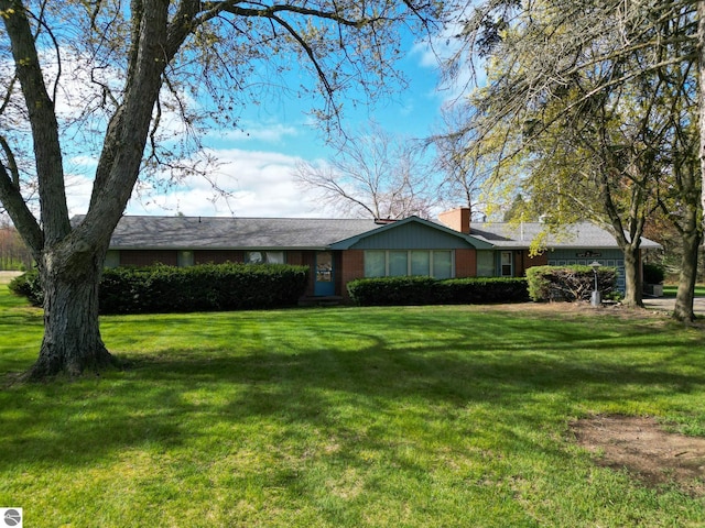 8670 E Pickard Rd, Mount Pleasant, MI 48858 - ranch-style house featuring a front yard, a chimney, and brick siding