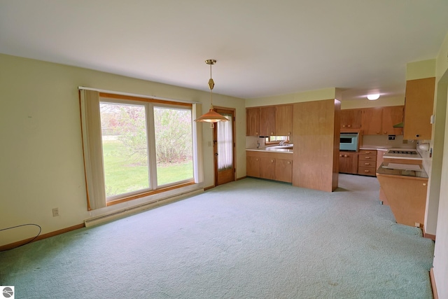 8670 E Pickard Rd, Mount Pleasant, MI 48858 - kitchen featuring baseboard heating, oven, light colored carpet, and a sink
