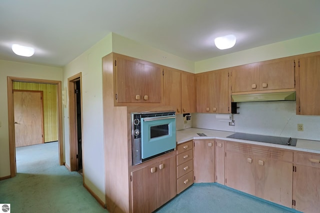 8670 E Pickard Rd, Mount Pleasant, MI 48858 - kitchen featuring black electric cooktop, under cabinet range hood, wall oven, light carpet, and light countertops