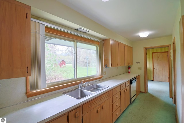 8670 E Pickard Rd, Mount Pleasant, MI 48858 - kitchen with dishwasher, a sink, light countertops, and light carpet