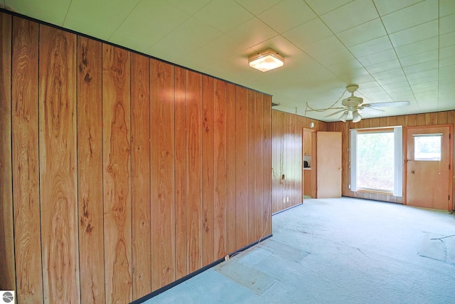 8670 E Pickard Rd, Mount Pleasant, MI 48858 - empty room featuring carpet flooring, wooden walls, and ceiling fan