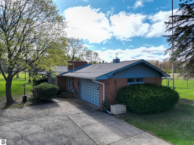 8670 E Pickard Rd, Mount Pleasant, MI 48858 - view of property exterior with brick siding, an attached garage, driveway, a lawn, and a chimney
