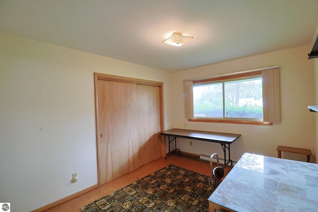 8670 E Pickard Rd, Mount Pleasant, MI 48858 - home office featuring carpet, baseboards, and a baseboard radiator