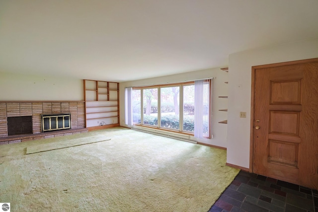 8670 E Pickard Rd, Mount Pleasant, MI 48858 - unfurnished living room featuring a brick fireplace, carpet flooring, and baseboards