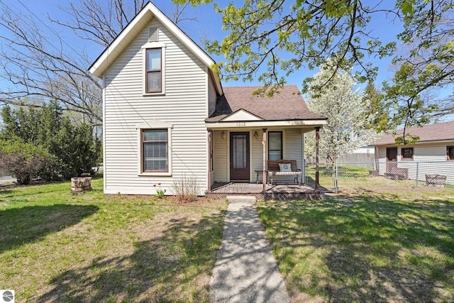 view of front of house featuring covered porch and a shingled roof