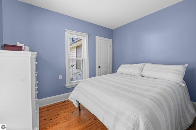 bedroom featuring wood finished floors and baseboards