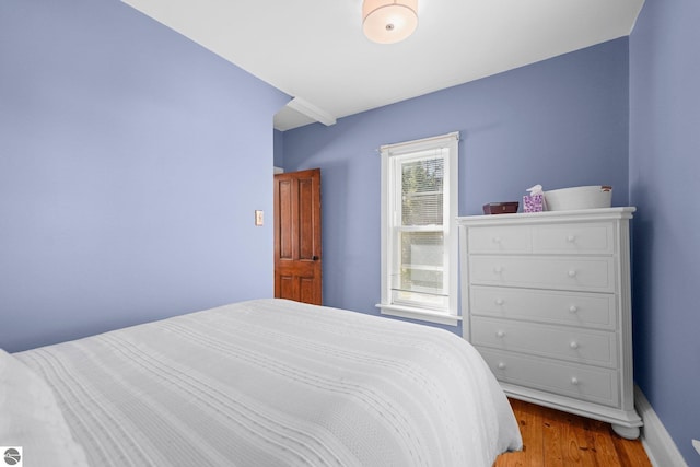 bedroom featuring wood finished floors and baseboards