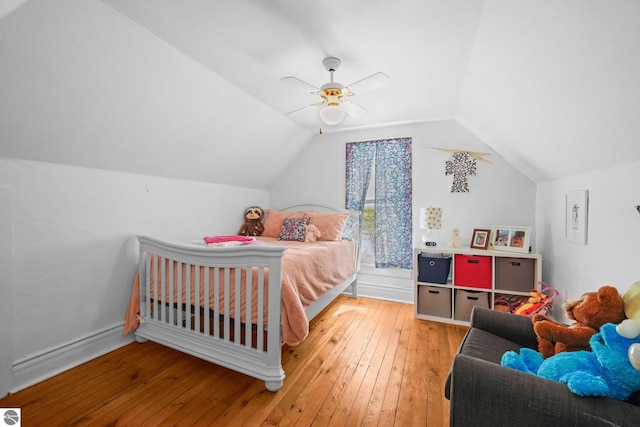 bedroom featuring hardwood / wood-style flooring, vaulted ceiling, and a ceiling fan