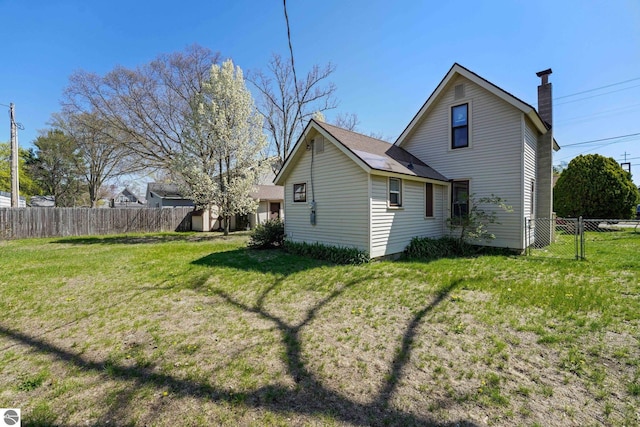 rear view of property featuring a chimney