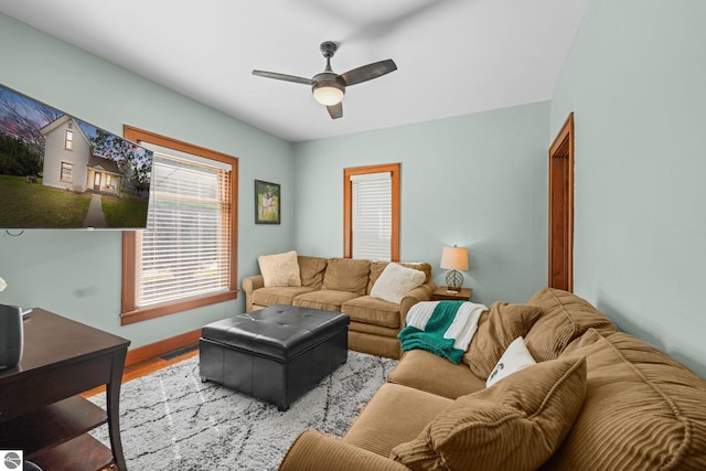 living area featuring wood finished floors and ceiling fan
