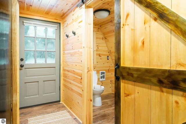 1428 Morel Ln, Grayling, MI 49738 - doorway featuring wood ceiling, light wood-type flooring, wooden walls, and heating unit