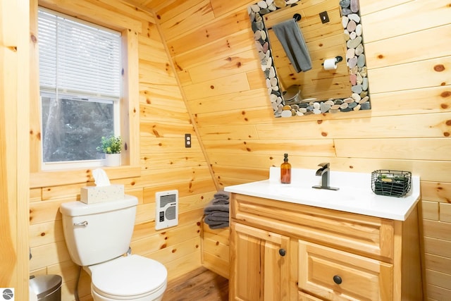 1428 Morel Ln, Grayling, MI 49738 - bathroom with wooden walls, toilet, vanity, and wood finished floors