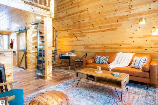 1428 Morel Ln, Grayling, MI 49738 - living room with a barn door, wooden walls, wood finished floors, and wooden ceiling