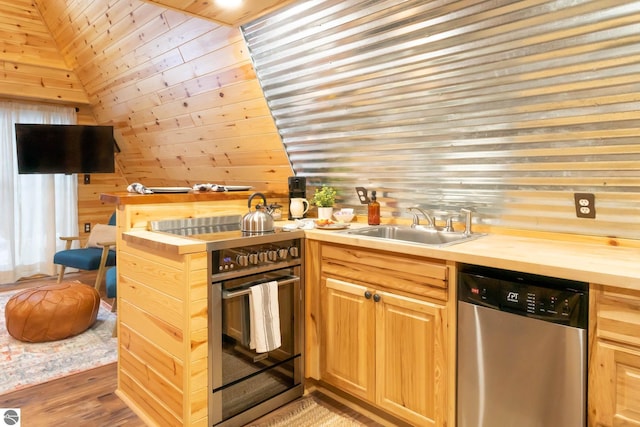 1428 Morel Ln, Grayling, MI 49738 - kitchen with stainless steel dishwasher, wooden counters, a sink, light wood finished floors, and wood walls