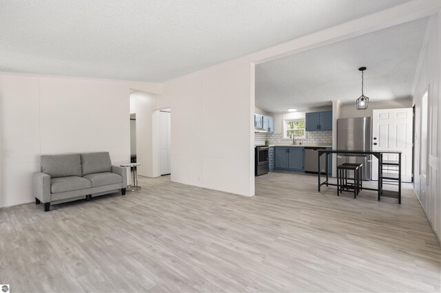 living area featuring light wood-style flooring and lofted ceiling