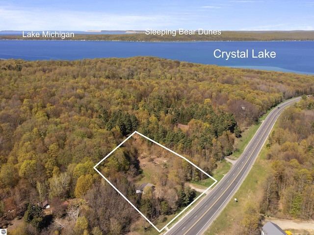 view of property location with a heavily wooded area, a nearby body of water, and property boundaries highlighted