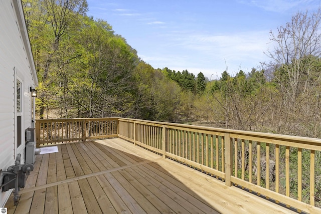 wooden deck featuring a view of trees