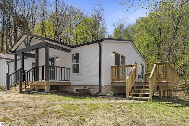 view of side of property featuring a deck and a lawn