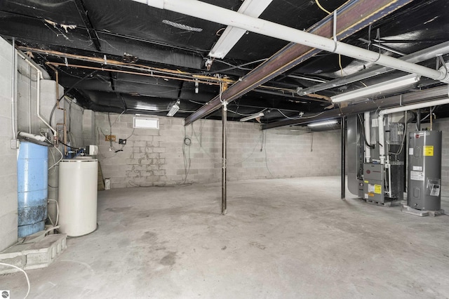 basement with water heater, gas water heater, and heating unit