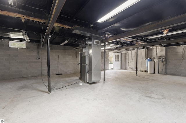 below grade area with heating unit and a water softener