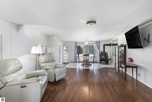 3121 Grace Rd, Frankfort, MI 49635 - living room featuring a wood stove, hardwood / wood-style flooring, and a ceiling fan
