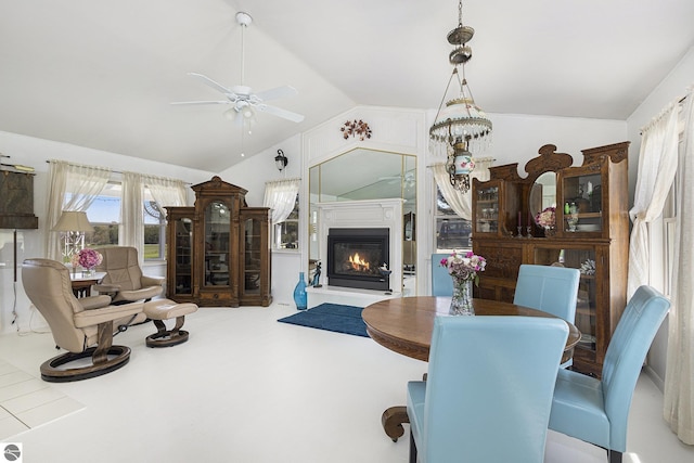 3121 Grace Rd, Frankfort, MI 49635 - dining room featuring lofted ceiling, ceiling fan, and a glass covered fireplace