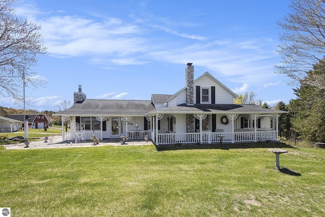 3121 Grace Rd, Frankfort, MI 49635 - country-style home with a porch, a front yard, and a chimney