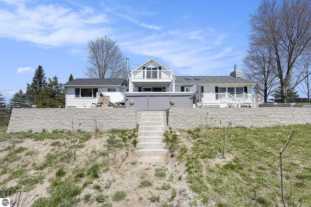 3121 Grace Rd, Frankfort, MI 49635 - view of front of property with stairs, a wooden deck, and a chimney