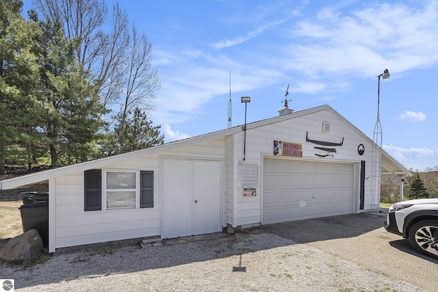 3121 Grace Rd, Frankfort, MI 49635 - view of front of house featuring a garage and an outbuilding