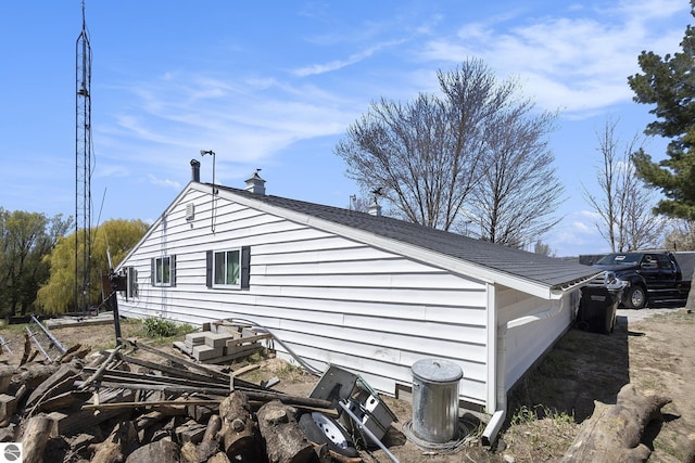 3121 Grace Rd, Frankfort, MI 49635 - view of side of home featuring a chimney