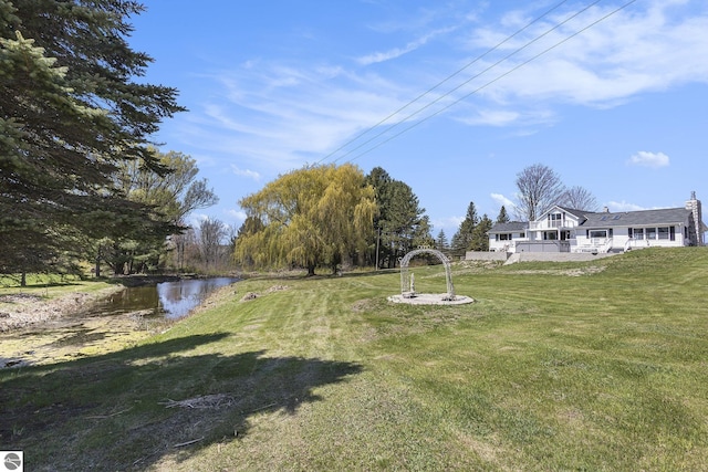 3121 Grace Rd, Frankfort, MI 49635 - view of grassy yard featuring a water view