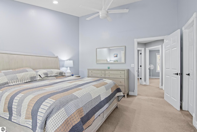 8256 Mapleleaf Dr, Traverse City, MI 49684 - bedroom with light colored carpet, a high ceiling, baseboards, and ceiling fan