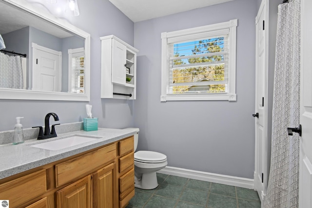 8256 Mapleleaf Dr, Traverse City, MI 49684 - bathroom featuring baseboards, vanity, toilet, and tile patterned floors