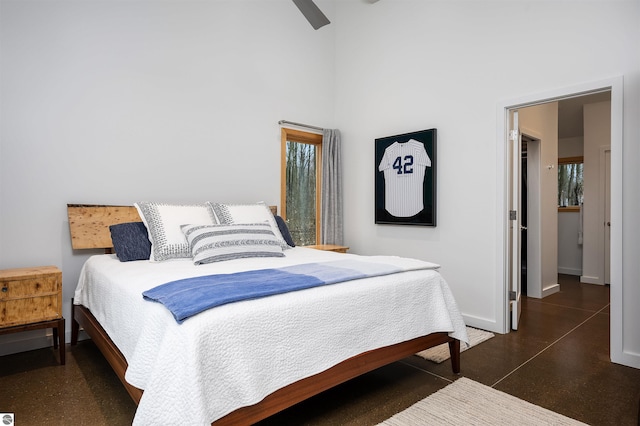20651 E Trails End Trl, Interlochen, MI 49643 - bedroom with baseboards, a high ceiling, and a ceiling fan