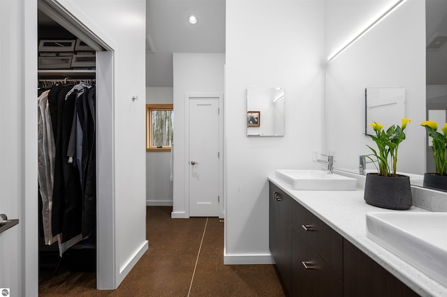 20651 E Trails End Trl, Interlochen, MI 49643 - full bath featuring baseboards, recessed lighting, double vanity, and a spacious closet