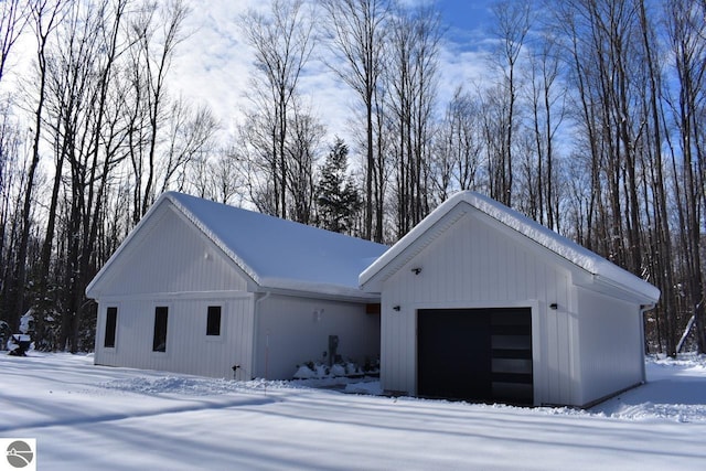 20651 E Trails End Trl, Interlochen, MI 49643 - view of front of house featuring an attached garage and an outdoor structure