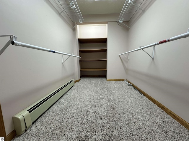 walk in closet with a baseboard radiator and carpet flooring